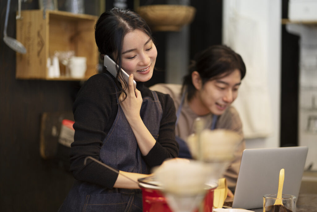 japanese woman talking smartphone restaurant